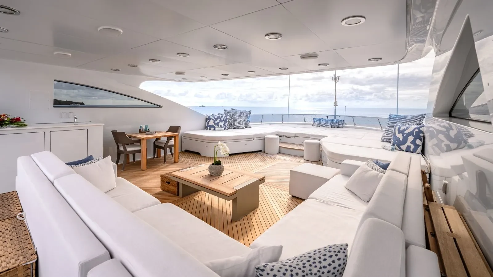 The covered outdoor lounge with panoramic sea views